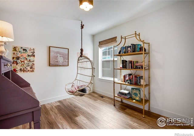 interior space featuring baseboards and wood finished floors