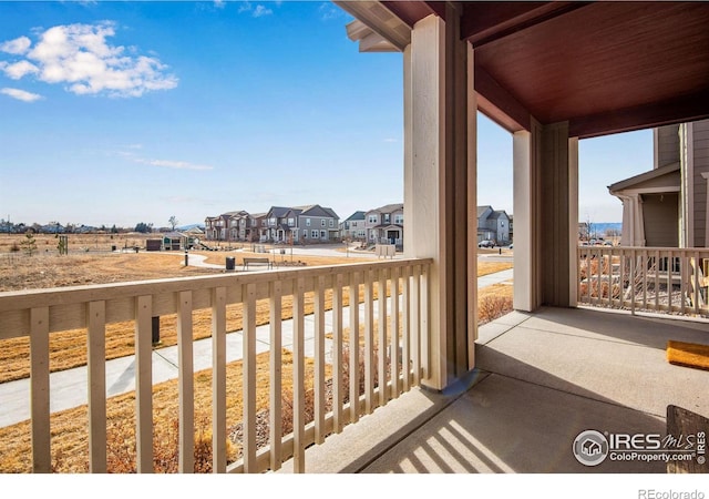 balcony featuring a residential view and covered porch