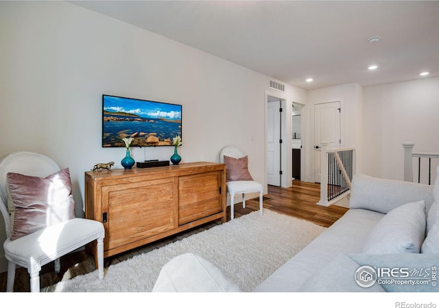 living area featuring wood finished floors, visible vents, and recessed lighting