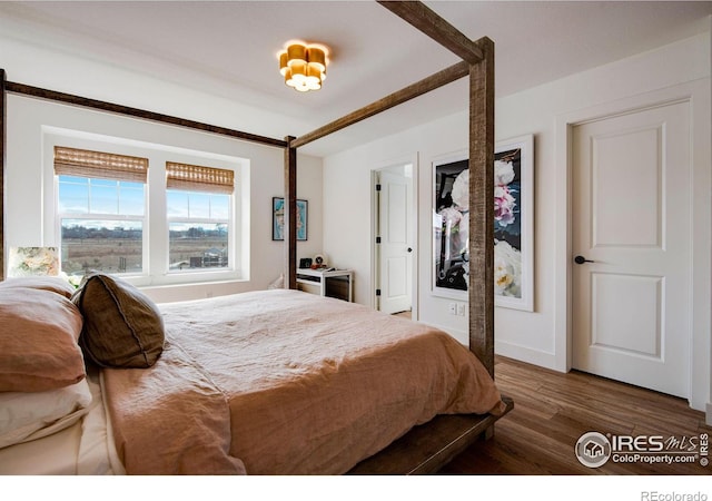 bedroom with wood finished floors