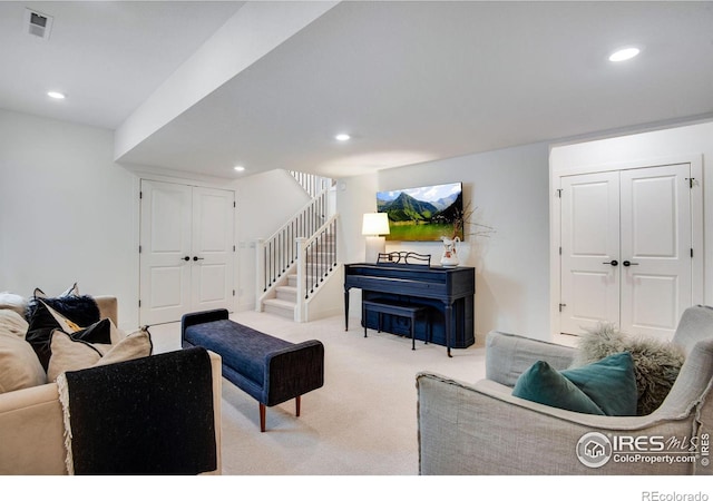 living room with stairs, carpet floors, visible vents, and recessed lighting