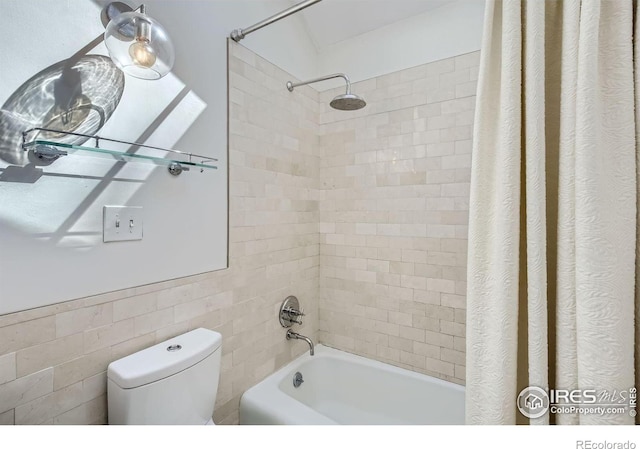 bathroom with shower / bath combo, tile walls, and toilet