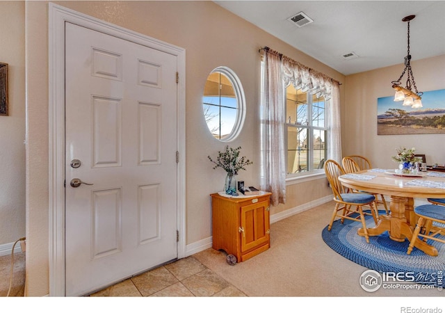 dining area with baseboards, visible vents, and light tile patterned flooring