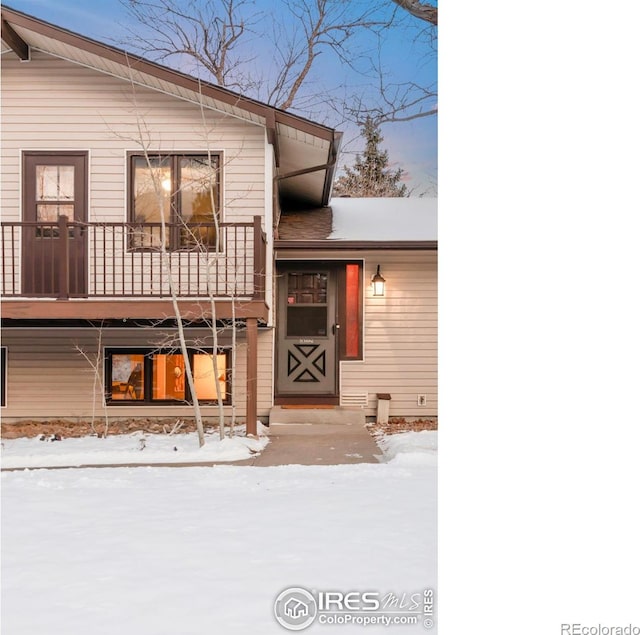 view of front of house featuring a balcony