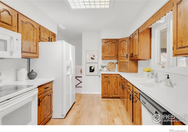 kitchen with tasteful backsplash, white appliances, and brown cabinets