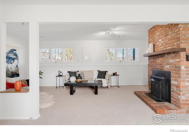 living area featuring a healthy amount of sunlight and carpet