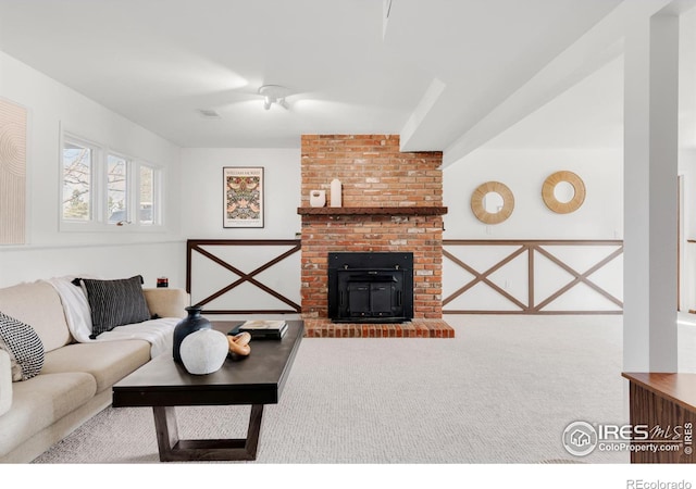 living area featuring a fireplace and carpet flooring