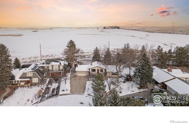 snowy aerial view with a residential view