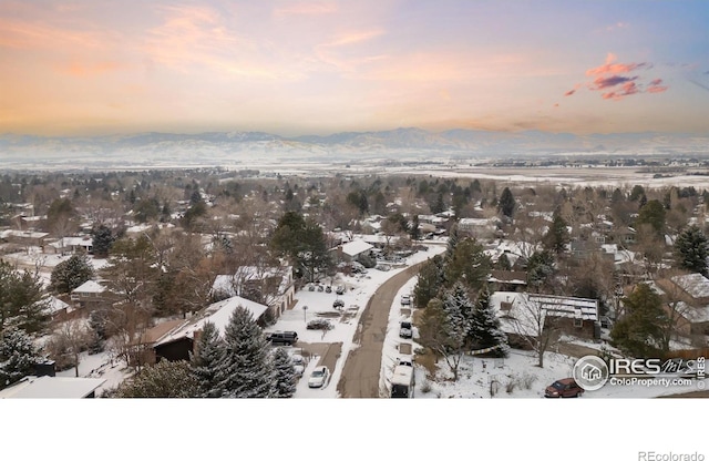 snowy aerial view with a mountain view