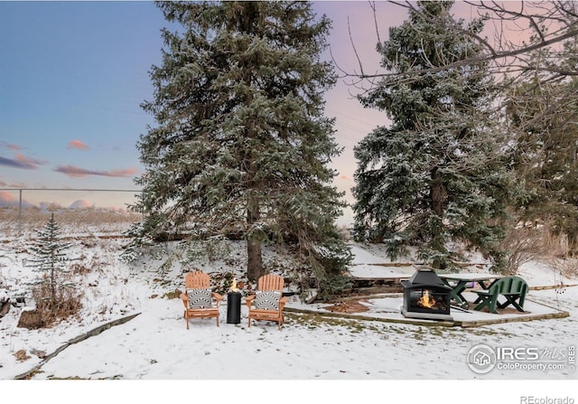 snowy yard with a fire pit