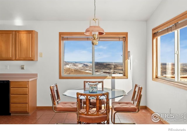 dining area featuring light tile patterned floors and baseboards