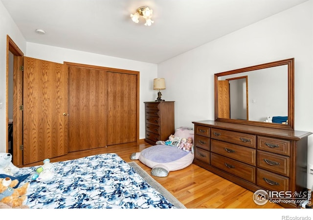 bedroom featuring light wood-style flooring and a closet