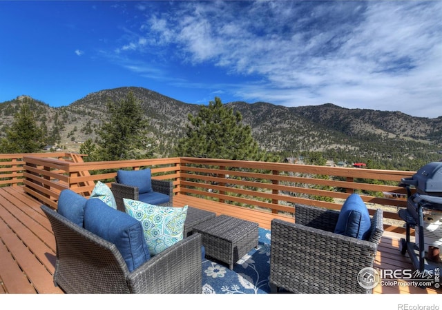 wooden deck featuring an outdoor living space, a grill, and a mountain view