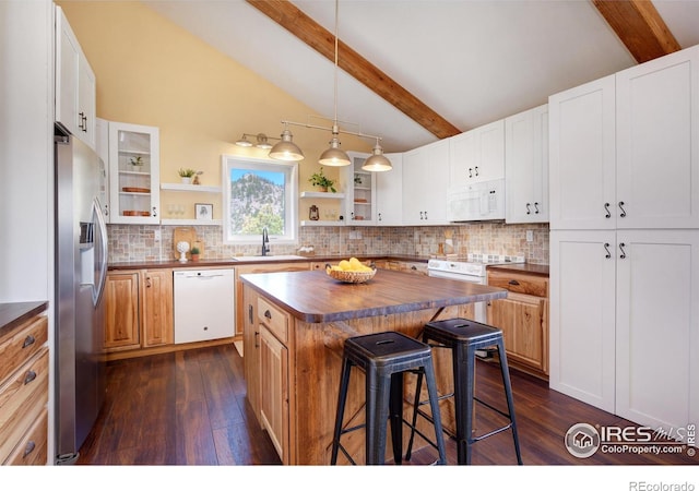 kitchen with a breakfast bar, open shelves, a sink, butcher block countertops, and white appliances