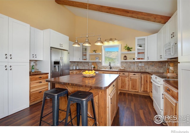 kitchen featuring dark wood-style floors, open shelves, lofted ceiling with beams, white appliances, and a kitchen bar