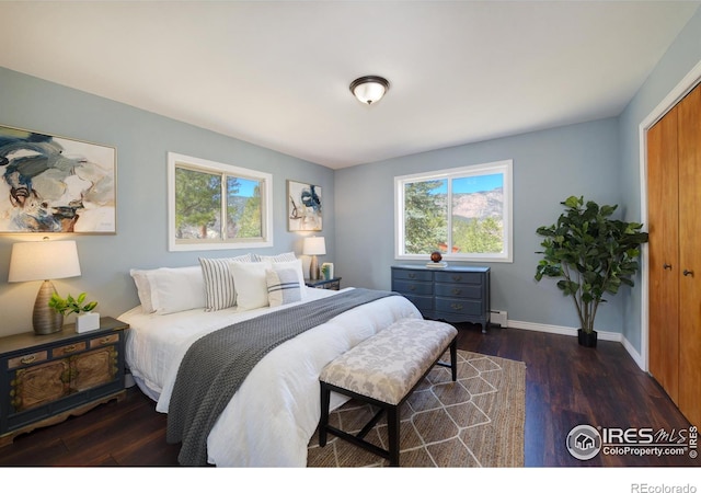 bedroom featuring wood finished floors and baseboards