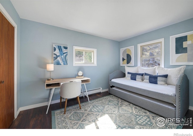 bedroom featuring multiple windows, baseboards, and wood finished floors