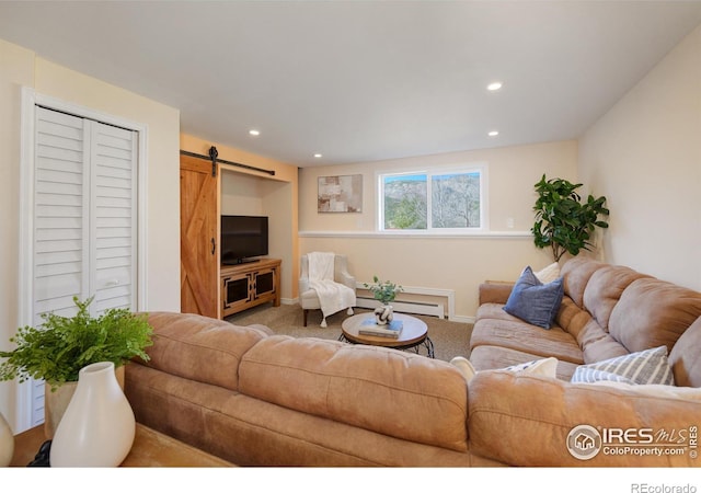 carpeted living area with a barn door, a baseboard heating unit, baseboards, and recessed lighting