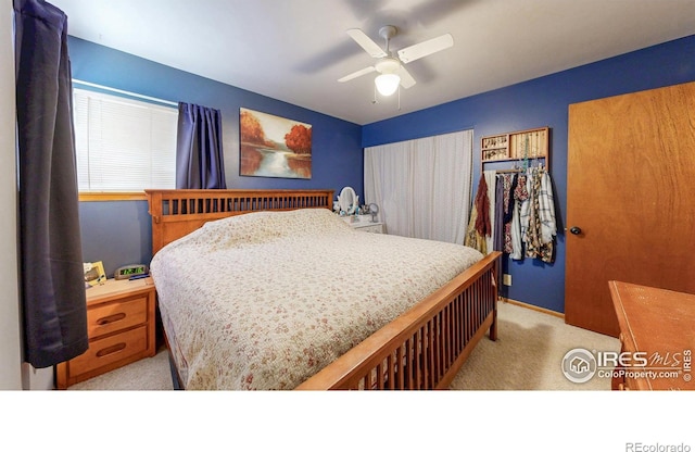 bedroom featuring light colored carpet and ceiling fan