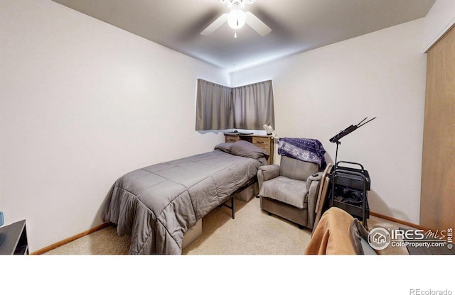 carpeted bedroom with a ceiling fan and baseboards