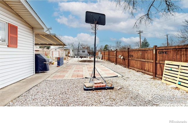 view of yard with a patio, an outdoor structure, and fence