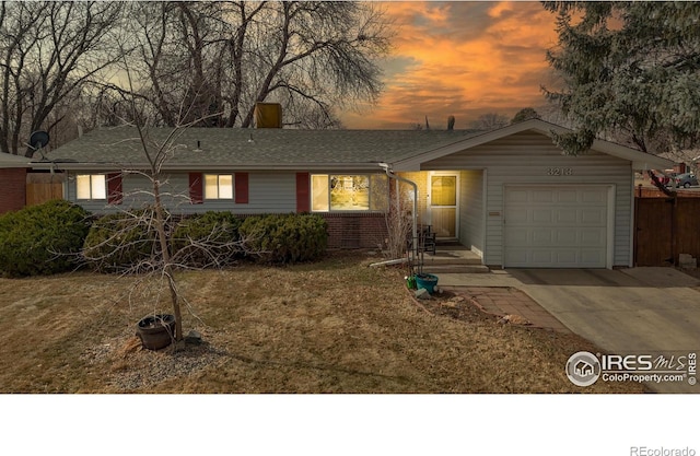 single story home with brick siding, driveway, and an attached garage