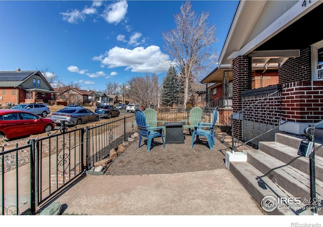 view of patio / terrace with fence and a residential view