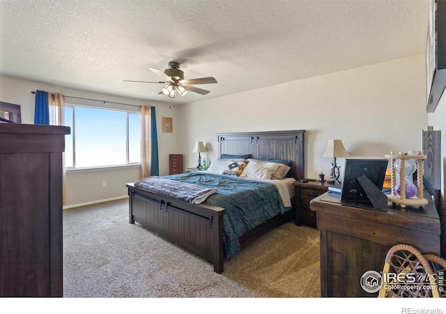 carpeted bedroom featuring a textured ceiling, ceiling fan, and baseboards