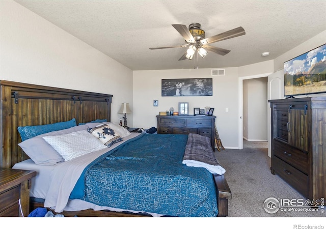 bedroom with baseboards, visible vents, ceiling fan, a textured ceiling, and carpet floors