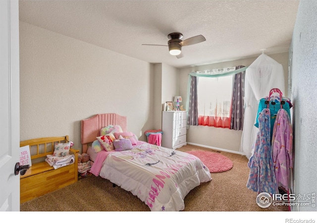 carpeted bedroom with ceiling fan and a textured ceiling