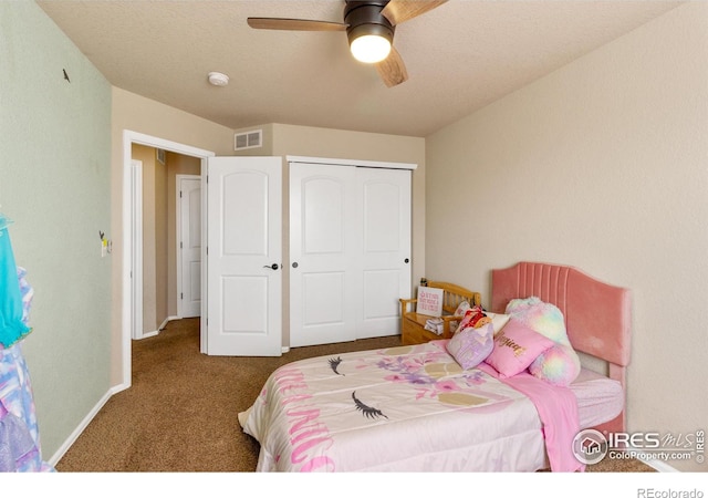 carpeted bedroom featuring a ceiling fan, baseboards, visible vents, and a closet