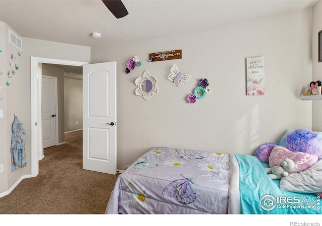 carpeted bedroom with a ceiling fan and visible vents