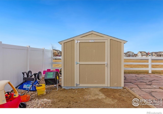 view of shed featuring fence