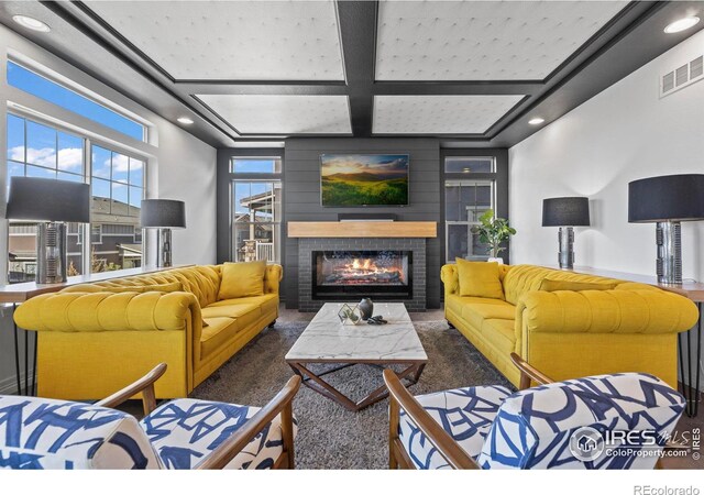 living room with visible vents, a brick fireplace, beamed ceiling, recessed lighting, and coffered ceiling