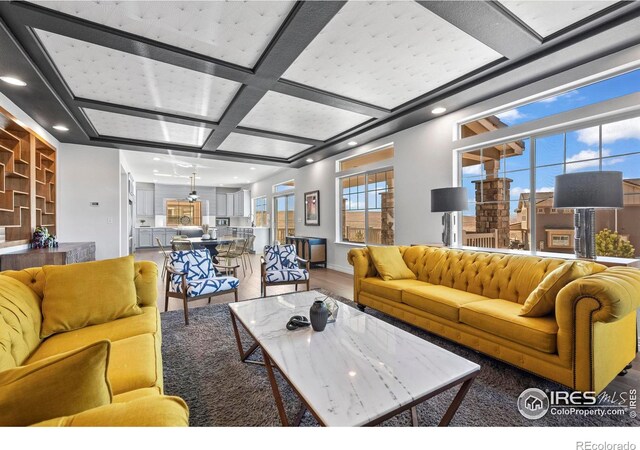 living room featuring recessed lighting, wood finished floors, baseboards, and coffered ceiling