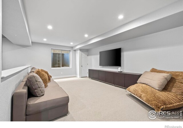 living area featuring recessed lighting, baseboards, and carpet