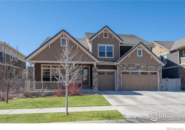 386 Painted Horse Way, Erie, CO 80516 - craftsman-style home featuring stone siding, concrete driveway, a garage, and a porch