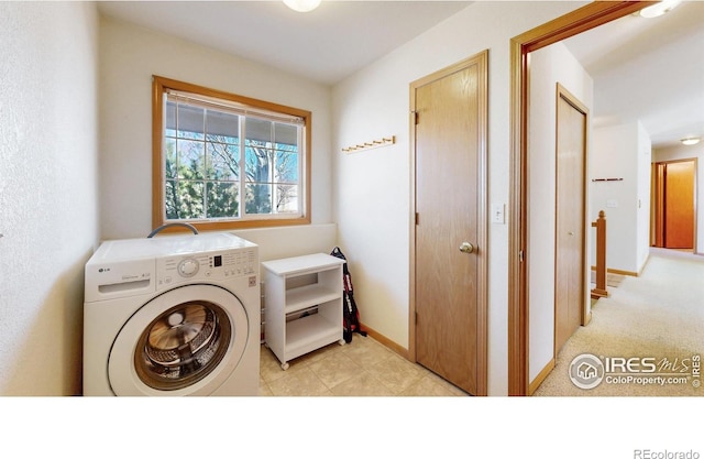 laundry area featuring laundry area, washer / dryer, and baseboards