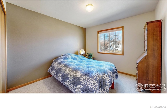 carpeted bedroom with baseboards