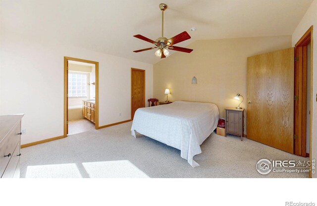 bedroom with lofted ceiling, connected bathroom, light carpet, a ceiling fan, and baseboards