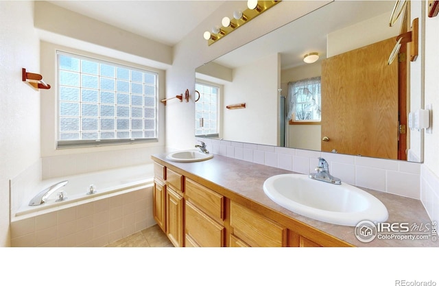 bathroom with a bath, plenty of natural light, and a sink