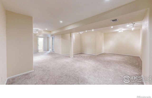 below grade area featuring carpet floors, recessed lighting, visible vents, and baseboards