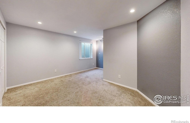 spare room with baseboards, carpet, and recessed lighting