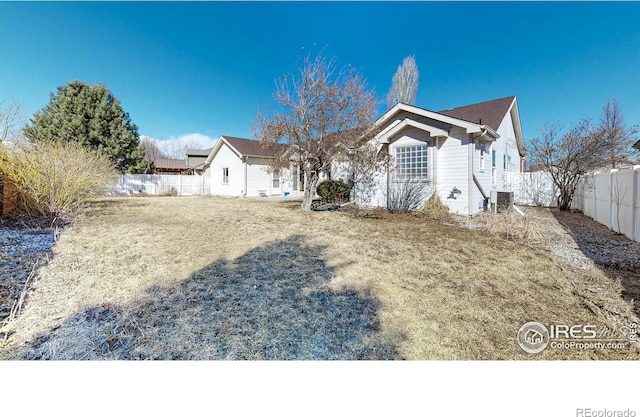 view of front of home featuring fence and cooling unit