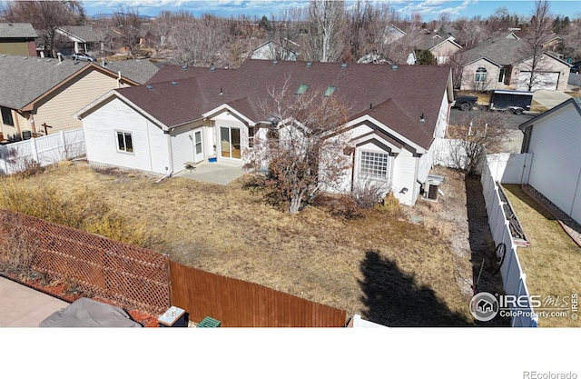 view of front of home featuring a fenced backyard, a residential view, and cooling unit