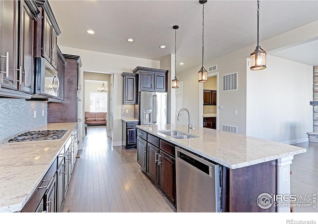 kitchen featuring visible vents, stainless steel appliances, and a sink