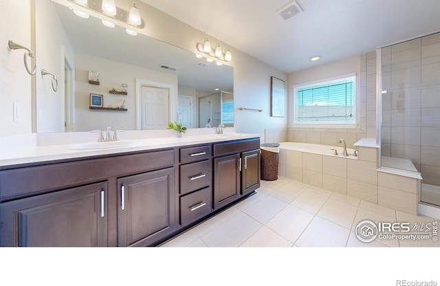 full bath with a garden tub, tile patterned flooring, visible vents, and a sink