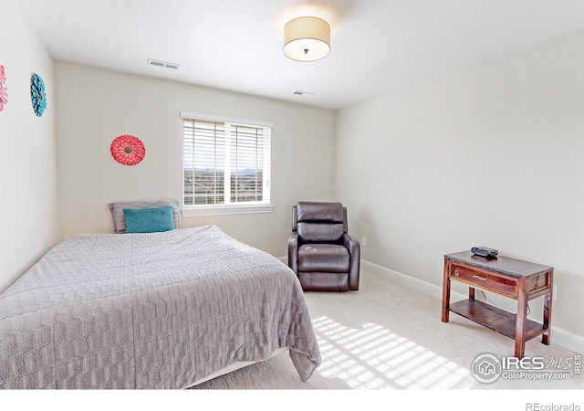 bedroom featuring carpet floors, visible vents, and baseboards