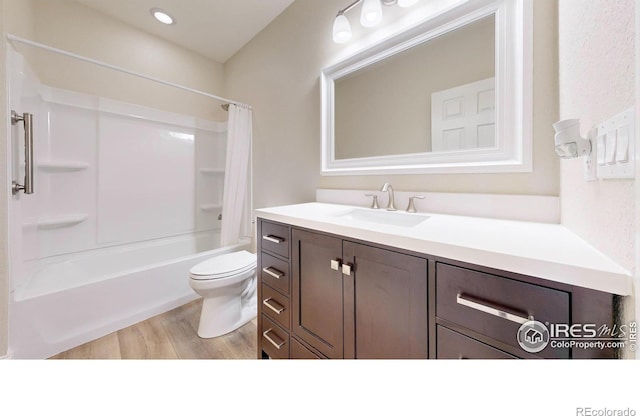 full bathroom with shower / bath combo, vanity, toilet, and wood finished floors