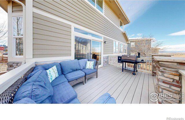 wooden deck featuring an outdoor living space and grilling area